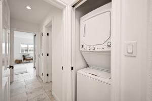 a white laundry room with a washer and dryer at 1313 S Coast Hwy in Laguna Beach
