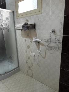 a shower stall in a bathroom with a shower at مبيت نسيم الجبل in AlUla