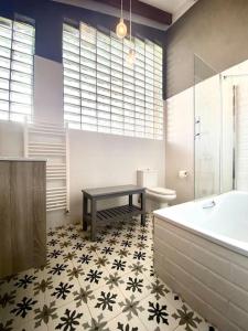 a bathroom with a table and a tub and a sink at La Rotella, calma al lado de Cangas de Onís in Cangas de Onís