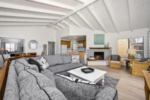 a living room with a couch and a table at Multi Level Oceanfront Home With Oceanviews and Private Patio on the Boardwalk in Newport Beach