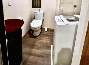 a small bathroom with a toilet and a sink at Suidobashi Ryokan - Vacation STAY 16177 in Osaka
