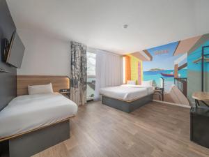 Postel nebo postele na pokoji v ubytování B&B HOTEL Fort-de-France