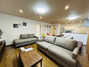ein Wohnzimmer mit einem Sofa und einem Tisch in der Unterkunft Mr,KINJO in RYCOM Kitanakagusuku - Vacation STAY 59274v in Shimabuku