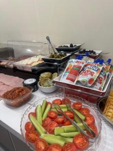 a buffet with vegetables and other foods on a counter at Floral Boutique Hotel in Pleven