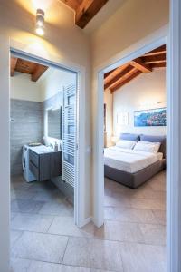 a bedroom with a large bed and a bathroom at Iseo Lake Villa con vista lago e piscina in Costa Volpino
