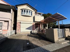 a house with a gate and a garage at Shin-SHIN-Kakamigahara - Vacation STAY 16114 in Kakamigahara