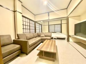 a living room with a couch and a coffee table at Geku-mae Bettei Hoshiori - Vacation STAY 65143v in Ise