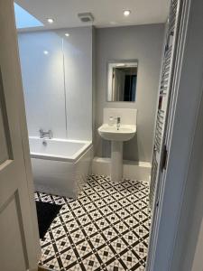 a bathroom with a sink and a bath tub and a sink at Luxury Apartment at Barron House in Nairn +9 photos