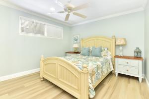 a bedroom with a bed and a ceiling fan at Updated Home on the Boardwalk with Private Rear Unit in Newport Beach