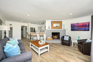 a living room with a couch and a fireplace at Updated Home on the Boardwalk with Private Rear Unit in Newport Beach
