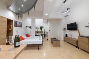 a living room with a white couch and a tv at Beautiful OCEANOGRAFIC Flats Valencia in Valencia