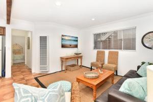 a living room with a couch and a table at 2 Bedroom BACK Apt at OCEANFRONT HOME on 15th St in Newport Beach