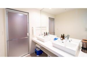 a bathroom with two sinks and a shower at Hotel Torifito Miyakojima Resort - Vacation STAY 79492v in Miyako Island