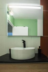 a bathroom with a sink and a mirror at *Cosy Home 20' Paris 25' Disney - Free WIFI* in Villiers-sur-Marne