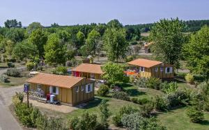 an aerial view of cottages in a park at Onlycamp Camping le Champ d'été in Reyssouze