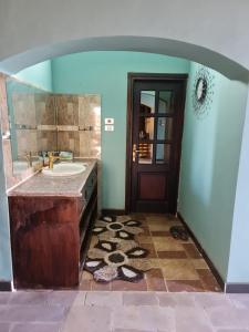 a bathroom with a sink and a mirror at Nubian Magic villa in Nag` el-Ramla