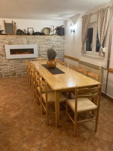 a dining room with a wooden table and chairs at Villa Lykos Plitvice in Plitvička Jezera