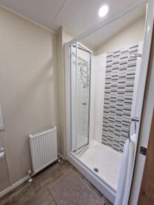 a bathroom with a shower with a glass door at Beautiful Caravan near Edinburgh nr 9 in Port Seton