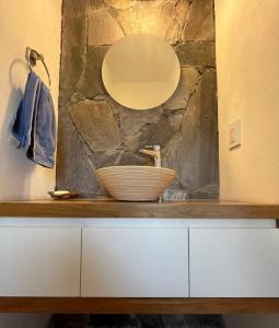 La salle de bains est pourvue d'un lavabo et d'un bol sur un comptoir. dans l'établissement Casa en Ascochinga B.° cerrado. Sierras de Córdoba, à Córdoba