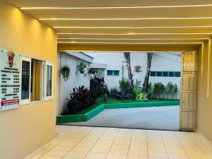an entrance to a building with an open door at Hotel Estoril Garden & Restaurante in Registro