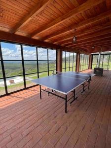 a ping pong table in a pavilion on a patio at Casa en Ascochinga B.° cerrado. Sierras de Córdoba in Cordoba