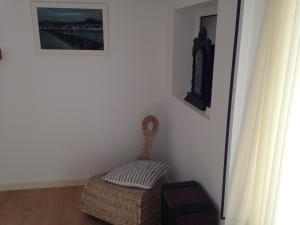 a room with a chair and a picture on the wall at Terraço da Vila in Ponte de Lima