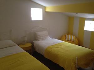 a hotel room with two beds and a window at Terraço da Vila in Ponte de Lima +14 photos