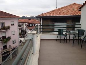 a balcony with a table and chairs on a building at Terraço da Vila in Ponte de Lima