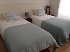 two beds sitting next to each other in a bedroom at Terraço da Vila in Ponte de Lima