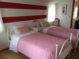two beds sitting next to each other in a bedroom at Terraço da Vila in Ponte de Lima