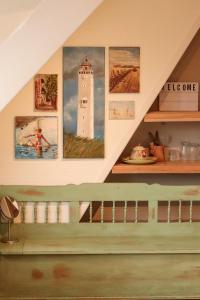 a staircase in a house with paintings on the wall at B&B Zee-en-Zo in Noordwijk
