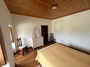 a bedroom with a bed and a dresser and a mirror at Casa do Alemao in Porto Judeu +17 photos