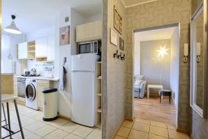 a kitchen with a white refrigerator and a table at Apartament Dzień dobry in Wałbrzych