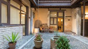 a home with a patio with potted plants at Casa de los Mozárabes by Toledo AP in Toledo