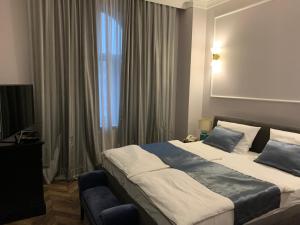 Postel nebo postele na pokoji v ubytování Hotel Balkan Centar