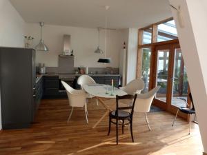 a kitchen and dining room with a table and chairs at Toad 5 on the Soederbring in Waddeweitz