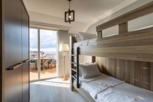 a bedroom with bunk beds with a view of the ocean at LİFE POOL SUİTE HOTEL in Trabzon