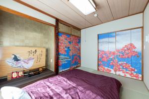 a bedroom with a purple bed and a window at Capricious Inn - Vacation STAY 16154 in Ebetsu