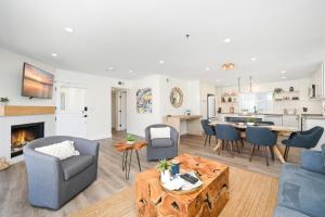 a living room with a table and chairs and a kitchen at Perfect Renovated and Modern Duplex on Balboa Island in Newport Beach