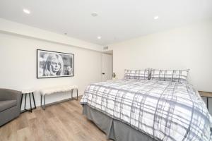 a white bedroom with a bed and a couch at Perfect Renovated and Modern Duplex on Balboa Island in Newport Beach