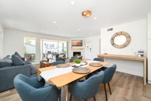a dining room and living room with a table and chairs at Perfect Renovated and Modern Duplex on Balboa Island in Newport Beach