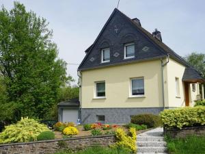 a yellow house with a black roof at Elisabeth on the Loreley in Biebernheim