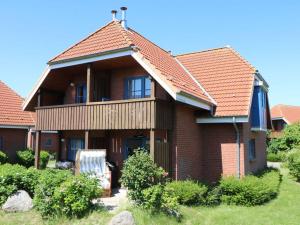a brick house with a red roof at Holiday apartment SeaSide in Westerbergen