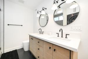 a bathroom with a sink and a mirror at 4 bedroom Renovated Home on Balboa Island in Newport Beach