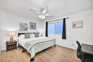 a bedroom with a bed and a ceiling fan at Charming 1-Bedroom Home on 29th Street in Newport Beach