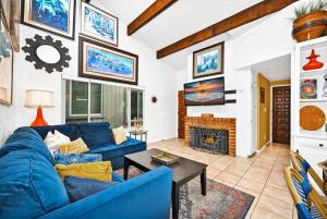 a living room with a blue couch and a fireplace at Spanish Castle By The Sea in Newport Beach in Newport Beach