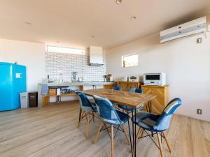 a kitchen and dining room with a wooden table and chairs at URBAN & BEACH - Vacation STAY 74389v in Awaji