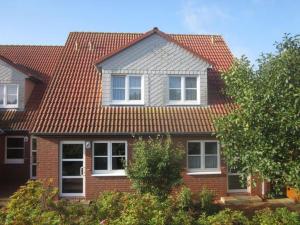 a brick house with a red roof at Holiday house house sound of the sea in Borkum