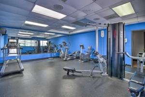 a gym with several tread machines and blue walls at Bright Galveston Condo with Balcony and Gulf Views! in Galveston