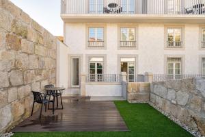 a patio with chairs and a table in front of a building at Host Wise - Fervença Boutique Palace in Vila Nova de Gaia